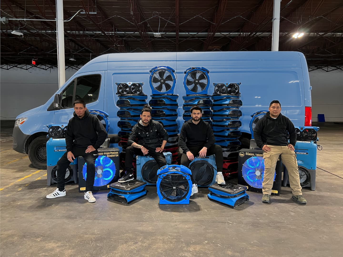Boston Restoration Prime team with air movers, dehumidifiers and a service van